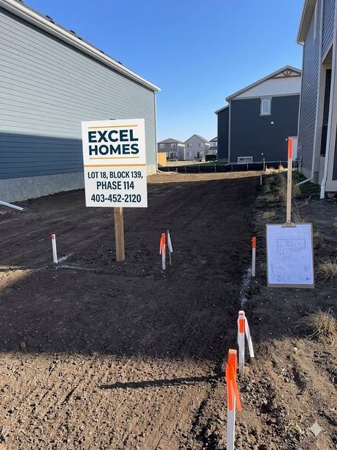 After — Excel Homes lot with professional sign